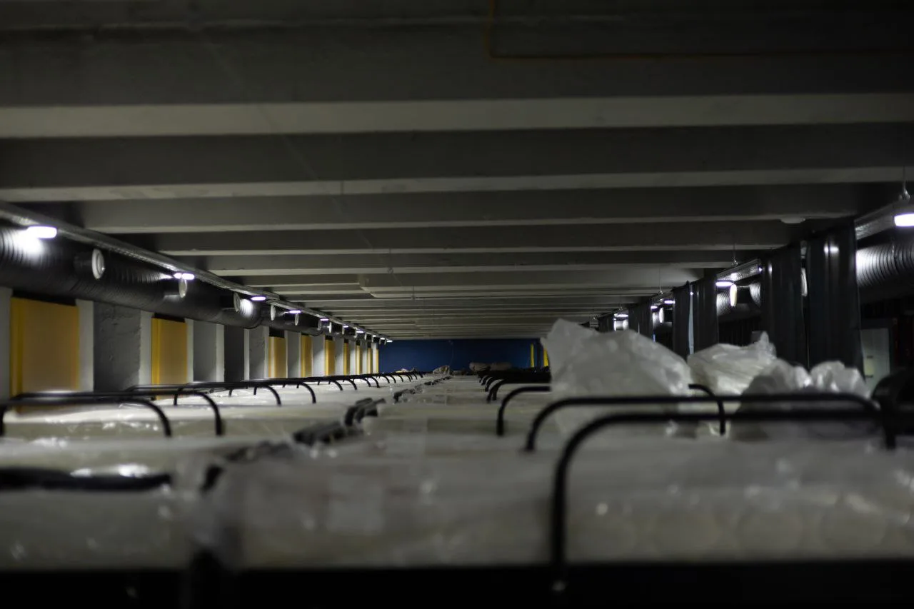 The sleeping sector of the bunker in Chuhuiv, launched by XTRAVERSE volunteers and partner organizations in late 2024. The photo shows bunk beds in the sleeping sector. The bunker was organized with the support of Skhid SOS, Fondation de France, Diakonie Katastrophenhilfe, United Sikhs, ArtDacha, and other partners. It was designed and developed by the Kharkiv-based studio cubureau, architect Anton Dmytrenko.