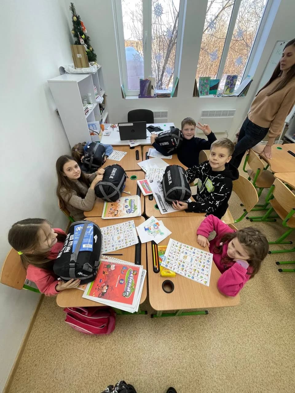The photo shows Tsyrkuny, Kharkiv region, 2023. Support for children: developmental activities and gifts from the "Ukraine - Berlin" foundation, including sleeping bags for children (Tsyrkuny has no permanent electricity supply). Developmental materials and gifts for children.